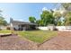 Wide backyard with a covered patio, a white fence, shed, hammock, and disc golf basket at 3511 E Crystal Lake Ave, Orlando, FL 32806
