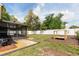 Spacious backyard with a patio, shed, white fence, hammock and a disc golf target at 3511 E Crystal Lake Ave, Orlando, FL 32806