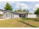 Charming single-story home with a well-manicured lawn, brick facade, and a cozy front porch sitting area at 3511 E Crystal Lake Ave, Orlando, FL 32806