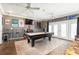 Spacious game room with a pool table, bar area, and ample space for entertaining guests at 3511 E Crystal Lake Ave, Orlando, FL 32806