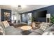 Stylish living room with blue accent wall, modern lighting, comfortable gray sofas and an open bar area at 3511 E Crystal Lake Ave, Orlando, FL 32806