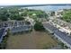 Aerial view of neighborhood homes with mature trees and a beautiful lake in the background at 3661 Brighton Park Cir, Orlando, FL 32812