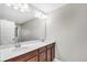 Neutral bathroom with a double sink vanity featuring modern fixtures and a large mirror at 3661 Brighton Park Cir, Orlando, FL 32812
