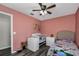 bedroom features stylish wood-look flooring and charming, salmon-colored walls at 3661 Brighton Park Cir, Orlando, FL 32812