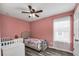 Bedroom with stylish wood-look floors and soft salmon walls at 3661 Brighton Park Cir, Orlando, FL 32812