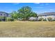Expansive community green space with a playground and a large tree, perfect for outdoor activities and gatherings at 3661 Brighton Park Cir, Orlando, FL 32812