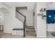 Hallway showing stairs and a half bath with modern decor at 3661 Brighton Park Cir, Orlando, FL 32812