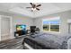 Bedroom with ceiling fan, desk, and large window overlooking the backyard at 3661 Brighton Park Cir, Orlando, FL 32812