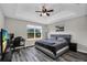 Bedroom showcasing tray ceiling, ample natural light, and wood-look flooring at 3661 Brighton Park Cir, Orlando, FL 32812