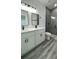 Modern bathroom featuring double vanity, sleek fixtures, and a glass-enclosed shower, offering a spa-like experience at 4634 Sw 170Th Road, Ocala, FL 34473