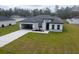 Inviting one-story home featuring a well-kept yard, gray accents, and a modern architectural design at 4634 Sw 170Th Road, Ocala, FL 34473