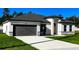 Lovely one-story home with a gray garage door, manicured lawn, and a bright, modern facade at 4634 Sw 170Th Road, Ocala, FL 34473