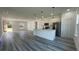 Spacious kitchen and living area with wood-look floors, a kitchen island and abundant natural light at 4634 Sw 170Th Road, Ocala, FL 34473