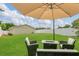 Relaxing backyard seating area with umbrella and firepit, perfect for enjoying evenings outdoors at 5345 Sunrise Blvd, Orlando, FL 32803