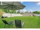 Relaxing lounge chairs and an umbrella in the spacious, well-maintained backyard of this home at 5345 Sunrise Blvd, Orlando, FL 32803