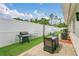 Landscaped backyard with patio, grill, outdoor seating, string lights, and a white fence at 5345 Sunrise Blvd, Orlando, FL 32803
