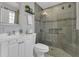 Modern bathroom featuring walk-in shower, tiled walls, vanity, large mirror, and decorative accents at 5345 Sunrise Blvd, Orlando, FL 32803