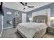 Comfortable bedroom featuring a gray padded headboard, soft bedding, and a ceiling fan at 5345 Sunrise Blvd, Orlando, FL 32803