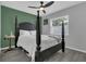 Bedroom featuring a gray wood floor, a black, four-post bed, and large window for natural light at 5345 Sunrise Blvd, Orlando, FL 32803
