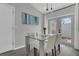 Bright dining area featuring a glass-top table with modern white chairs at 5345 Sunrise Blvd, Orlando, FL 32803