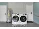 Bright laundry room with new washer and dryer, hot water heater, and charming decor at 5345 Sunrise Blvd, Orlando, FL 32803