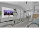 Spacious living area with a comfortable sofa, modern TV, and a dining area in the background at 5345 Sunrise Blvd, Orlando, FL 32803