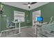 Bright home office featuring standing desks, modern chair, ceiling fan, and window letting in natural light at 5345 Sunrise Blvd, Orlando, FL 32803
