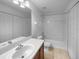 Clean bathroom featuring a single vanity, tiled floors, and a shower-tub combo, offering both style and functionality at 5413 River Rock Rd, Lakeland, FL 33809