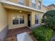 Charming two-story home showcasing a covered front entrance with brick-paved detail and a manicured garden at 5413 River Rock Rd, Lakeland, FL 33809