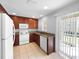 Well-equipped kitchen featuring wood cabinets, white appliances, and a sliding door leading to the patio at 5413 River Rock Rd, Lakeland, FL 33809