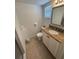 Cozy bathroom featuring a granite countertop and white cabinets at 573 N Atlantic Ave # 5, New Smyrna Beach, FL 32169