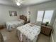 Comfortable bedroom features two twin beds, neutral decor, and a ceiling fan at 573 N Atlantic Ave # 5, New Smyrna Beach, FL 32169