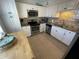 Functional kitchen features granite counters, stainless steel appliances, and ample cabinet storage at 573 N Atlantic Ave # 5, New Smyrna Beach, FL 32169