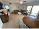 Comfortable living room featuring a sofa, ceiling fan, and sliding glass doors to the exterior at 573 N Atlantic Ave # 5, New Smyrna Beach, FL 32169