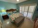 Relaxing main bedroom featuring a large bed, soft lighting, and bright windows at 573 N Atlantic Ave # 5, New Smyrna Beach, FL 32169