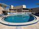 Inviting community pool with lounge chairs at 573 N Atlantic Ave # 5, New Smyrna Beach, FL 32169