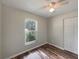 Cozy bedroom with ceiling fan, closet, neutral walls, and window with outside view at 6740 Se 107Th St, Belleview, FL 34420