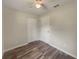 Neutral bedroom with wood floors, closet, and simple lighting fixture at 6740 Se 107Th St, Belleview, FL 34420