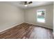 Bright bedroom featuring wood-look flooring and a window offering a view of the backyard pool at 6740 Se 107Th St, Belleview, FL 34420