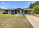 Charming home featuring a covered portico and freshly painted exterior with dark shutters at 6740 Se 107Th St, Belleview, FL 34420