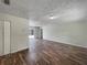 Bright living room featuring hardwood floors, neutral walls, and modern light fixture at 6740 Se 107Th St, Belleview, FL 34420