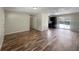 Spacious living room featuring hardwood floors, neutral walls, and sliding glass doors to outdoor space at 6740 Se 107Th St, Belleview, FL 34420
