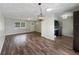 Open-concept living area with wood flooring, a dining area, and views into the updated kitchen at 6740 Se 107Th St, Belleview, FL 34420
