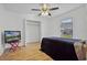 Bedroom features wood floors, ceiling fan, closet, and window for natural light at 7606 Fordham Creek Ln, Orlando, FL 32818