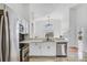 Bright kitchen featuring stainless steel appliances, white cabinetry, and a view into the living room at 7606 Fordham Creek Ln, Orlando, FL 32818