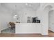 Bright kitchen with white cabinets, black appliances, and an arched doorway to the dining area at 7606 Fordham Creek Ln, Orlando, FL 32818