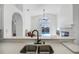 View from kitchen of the living room and the pool area outside at 7606 Fordham Creek Ln, Orlando, FL 32818