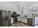 Bright kitchen with stainless steel appliances, white cabinetry, and tile floors at 7606 Fordham Creek Ln, Orlando, FL 32818