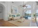 Inviting living room with vaulted ceilings, neutral decor and views of the pool area at 7606 Fordham Creek Ln, Orlando, FL 32818