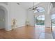Living room features vaulted ceilings, wood floors and a sliding door with a view of the pool at 7606 Fordham Creek Ln, Orlando, FL 32818